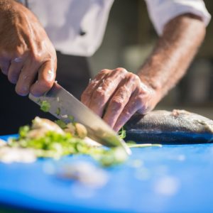 Chef using a knife to chop food